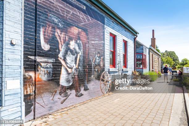 the street view of sheffield town in tasmania, australia - mural stock pictures, royalty-free photos & images