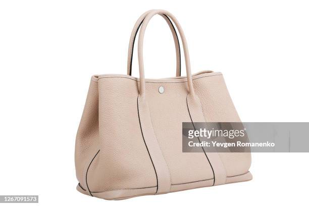 beige leather handbag isolated on white background - beige purse stockfoto's en -beelden