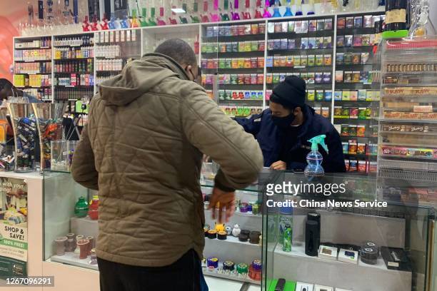 Customer buys cigarettes at a tobacconist amid the coronavirus outbreak on August 18, 2020 in Johannesburg, South Africa.