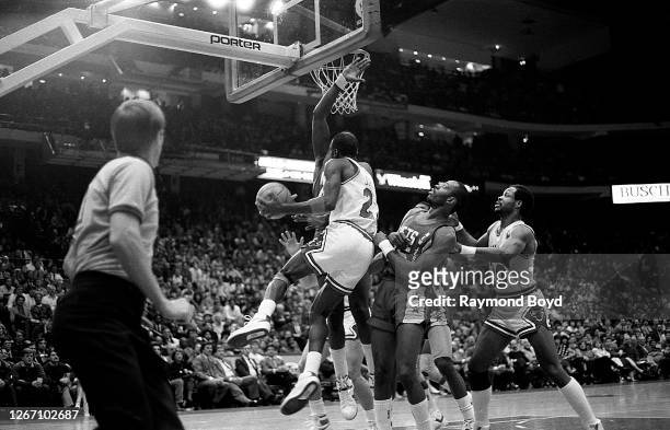 Chicago Bulls guard Michael Jordan goes up for a reverse layup during a game against the New Jersey Nets at Chicago Stadium in Chicago, Illinois in...
