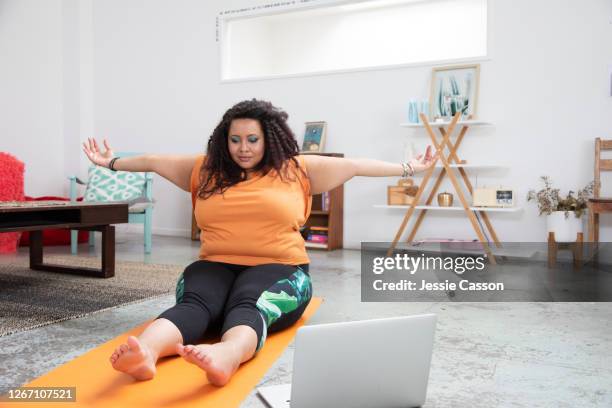 a woman does yoga in a loft apartment - auckland covid stock pictures, royalty-free photos & images