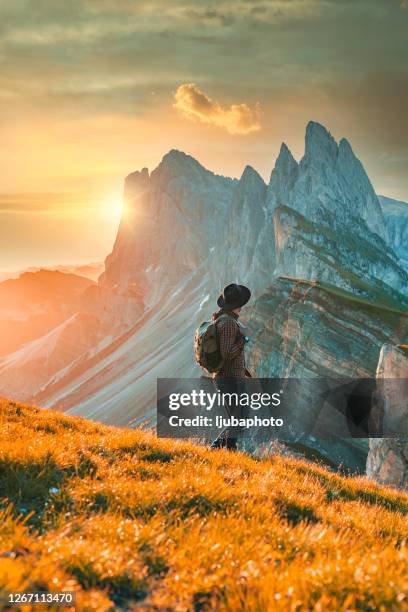 traveller with a backpack standing on a mountain peak - alto adige stock pictures, royalty-free photos & images