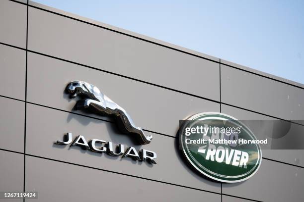 Close-up of a Jaguar Land Rover sign at a car garage on July 22, 2020 in Cardiff, Wales. Many UK businesses are announcing job losses due to the...