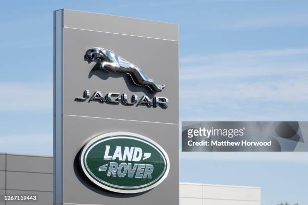 Close-up of a Jaguar Land Rover sign at a car garage on July 22, 2020 in Cardiff, Wales. Many UK businesses are announcing job losses due to the...