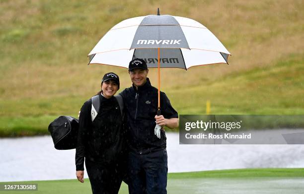 Oliver Fisher of England and his sister Georgina Fisher who is caddying for him this week on the 18th hole during a practice round prior to the Wales...