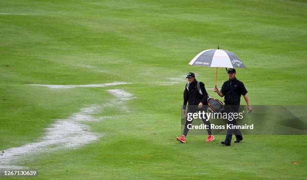 Oliver Fisher of England and his sister Georgina Fisher who is caddying for him this week on the 18th hole during a practice round prior to the Wales...