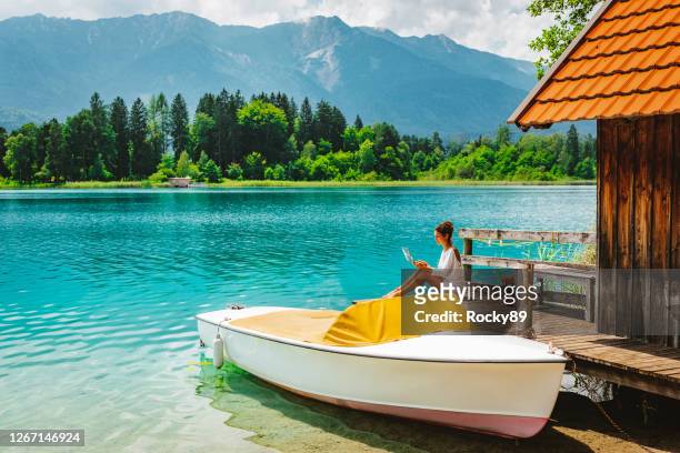 remote working and enjoying bleisure time at lake faak in austria - austria stock pictures, royalty-free photos & images