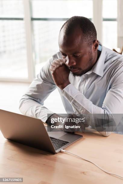 an office programmer works on correcting errors in the execution of a complex program - execution table stock pictures, royalty-free photos & images