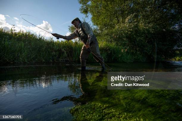 Fly fisherman takes on a section of the river Darent hoping to catch Brown Trout that they intend to return to the water on August 18, 2020 in...