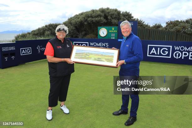 Laura Davies of England receives a gift from R&A Chief Executive Martin Slumbers to commemorate her 40th appearance at the Women's Open Championship...