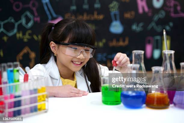 cheerful of young girl kid learning science experiment in chemical classroom - very young tube stock pictures, royalty-free photos & images