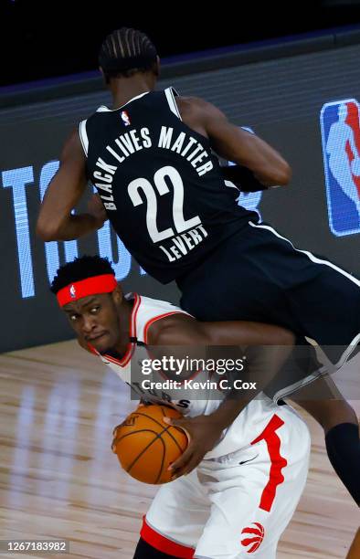 Pascal Siakam of the Toronto Raptors draws a foul from Caris LeVert of the Brooklyn Nets during the first quarter in Game Two of the Eastern...