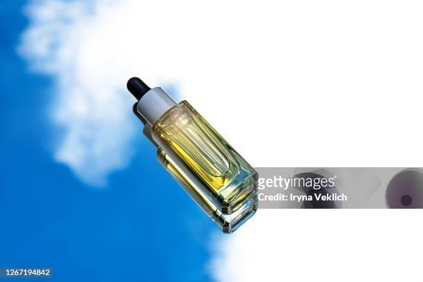 luxury cosmetic bottle serum on sky background. - seoul stock photos et images de collection