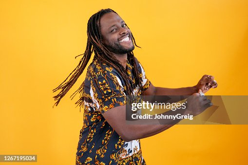Three-quarter profile of smiling mid adult black man dancing Three-quarter profile of smiling mid adult black man dancing