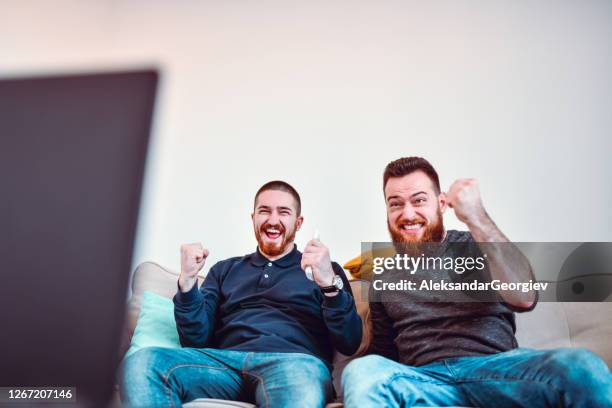male friends watching intense sports match - watching sport television stock pictures, royalty-free photos & images