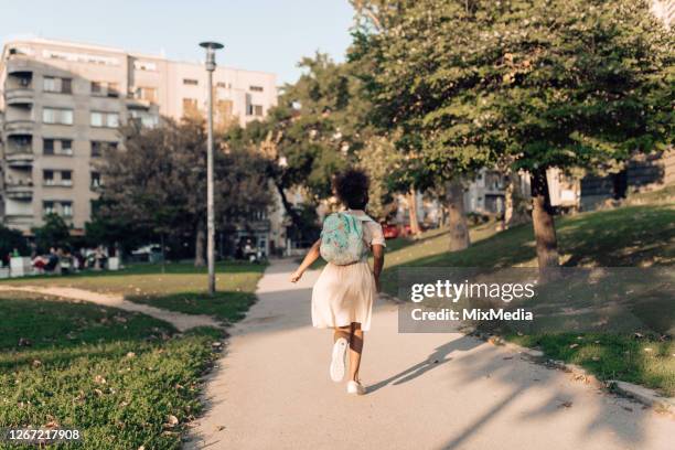 girl running to school - afro back stock pictures, royalty-free photos & images