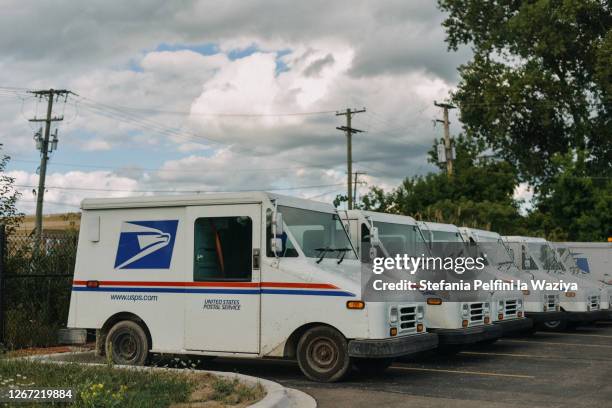 usps truck parked in line - united states postal service stock pictures, royalty-free photos & images