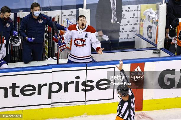 Brendan Gallagher of the Montreal Canadiens complains to referee Kyle Rehman as he bleeds from the mouth for the lack of a penalty call against the...
