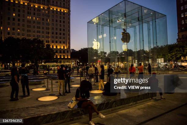 People line up outside the Apple store on Fifth Avenue on August 19, 2020 in New York City. Tech giant Apple has become the first American company to...