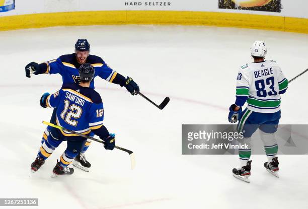 Zach Sanford of the St. Louis Blues scores at 5:51 of the second period against the Vancouver Canucks and is joined by Tyler Bozak in Game Five of...
