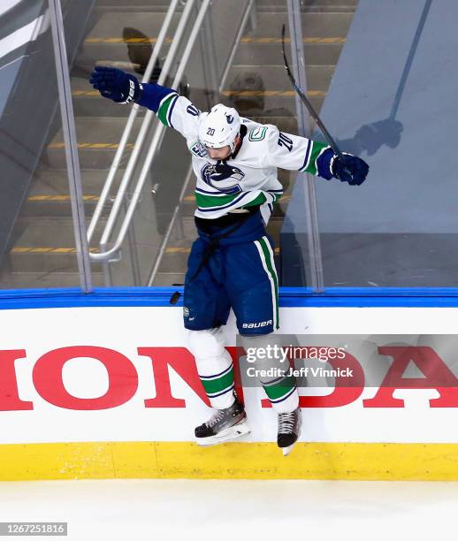 Brandon Sutter of the Vancouver Canucks hits the boards trying to stop a puck during the second period against the St. Louis Blues in Game Five of...