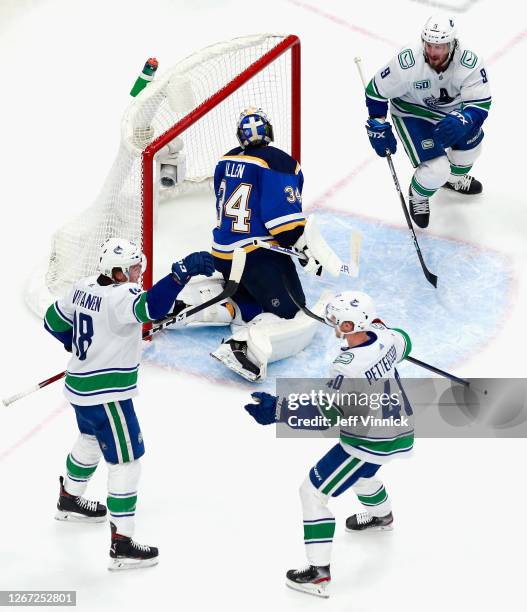 Jake Virtanen of the Vancouver Canucks celebrates his goal at 16:08 of the second period against Jake Allen of the St. Louis Blues and is joined by...