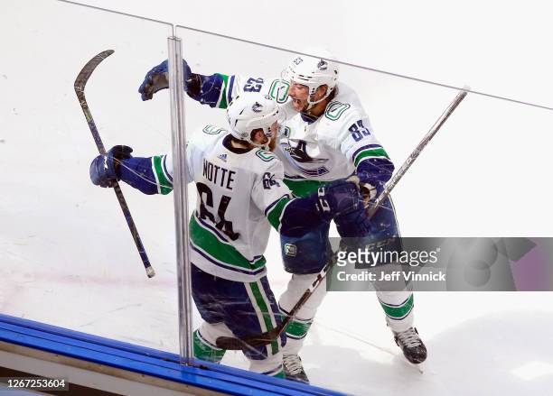 Tyler Motte of the Vancouver Canucks celebrates his goal at 18:17 of the second period against the St. Louis Blues and is joined by Jay Beagle in...