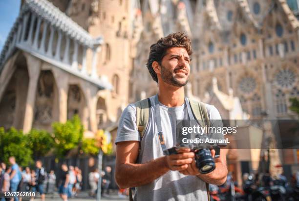 mid adult male tourist sightseeing with camera in barcelona - tourist camera stock pictures, royalty-free photos & images