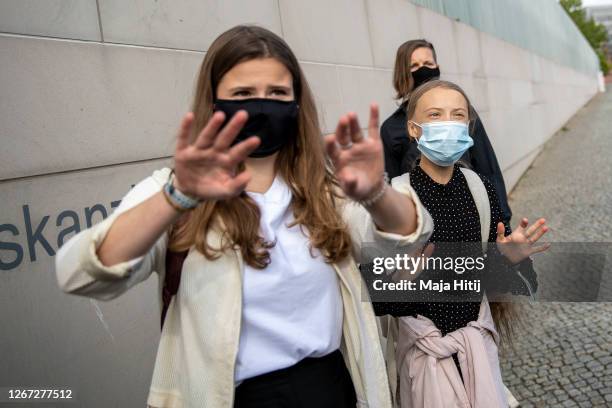 Swedish climate activist Greta Thunberg and German climate activist Luisa Neubauer tell press to move away as they arrive for the meeting with German...