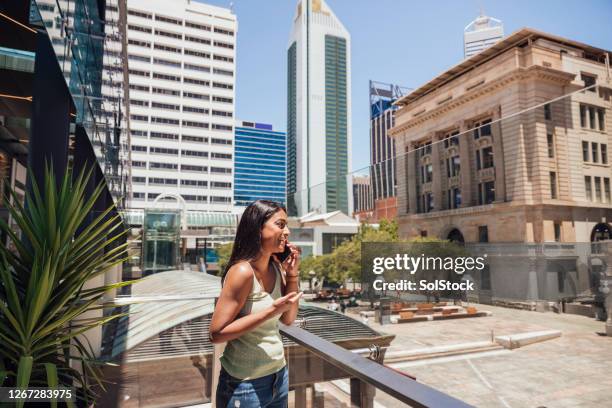 woman on phone in urban environment - perth city people stock pictures, royalty-free photos & images