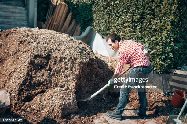 man raking top soil - topsoil stock pictures, royalty-free photos & images