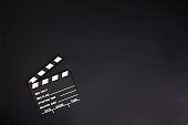 clapper board or movie slate.It is used in video production and film industry on black background. High quality photo. Copy space.