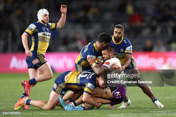 Sandor Earl of the Storm is tackled during the round 15 NRL match between the Parramatta Eels and the Melbourne Storm at Bankwest Stadium on August...