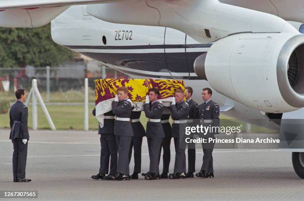 Regiment airmen carry the coffin of Diana, Princess of Wales , which is draped with a Royal Standard, as she is repatriated after her arrival in a...