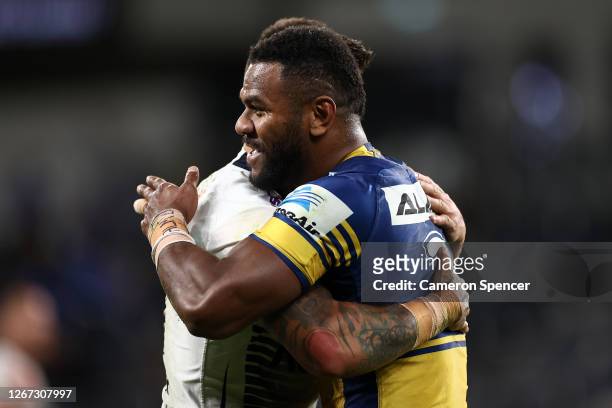 Sandor Earl of the Storm and Maika Sivo of the Eels embrace after the round 15 NRL match between the Parramatta Eels and the Melbourne Storm at...