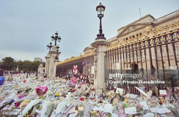 Floral tributes and messages of condolence in memory of British Royal Diana, Princess of Wales , are left outside Buckingham Palace in London,...