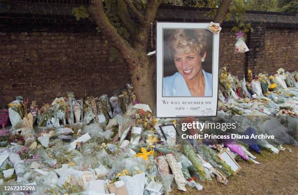 Photograph of British Royal Diana, Princess of Wales with floral tributes and messages of condolence outside Kensington Palace in London, England,...