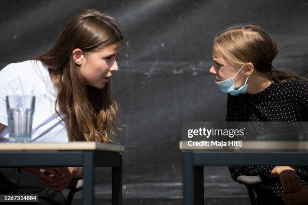 German climate activist Luisa Neubauer and Swedish climate activist Greta Thunberg speak during a press conference following the meeting with German...