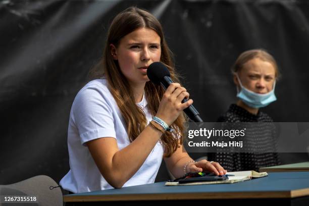 German climate activist Luisa Neubauer speaks next to Swedish climate activist Greta Thunberg during a press conference following the meeting with...