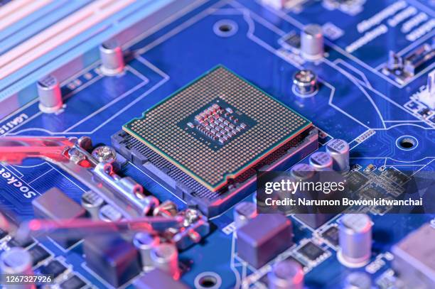 the close up image of the cpu socket and motherboard laying on the table - semiconductor stockfoto's en -beelden