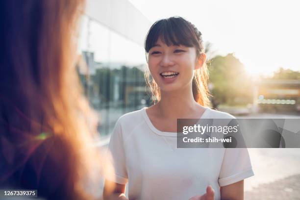 chatting with female friends outdoors - narrating stock pictures, royalty-free photos & images