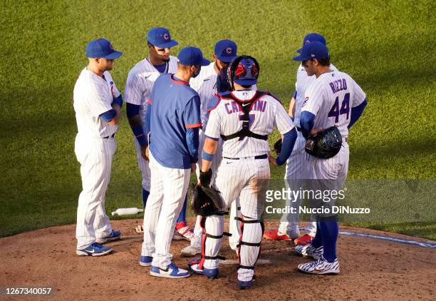 Pitching coach Tommy Hottovy of the Chicago Cubs visits the mound to speak with Jeremy Jeffress during the sixth inning of Game Two of a doubleheader...