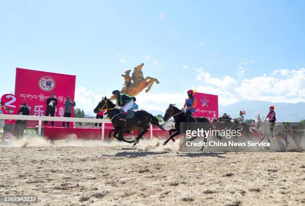 Equestrians perform stunt on horseback during the Sho Dun Festival on August 20, 2020 in Lhasa, Tibet Autonomous Region of China.