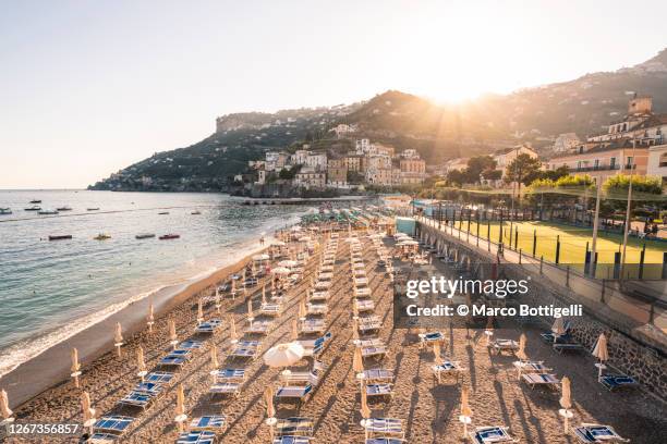 equipped beach along amalfi coast, italy - minori stock pictures, royalty-free photos & images