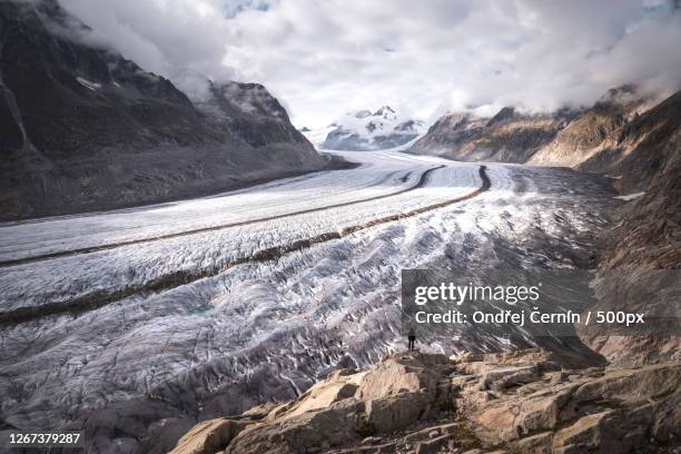 giant aletsch glacier -alps, tiny human - aletsch glacier stock pictures, royalty-free photos & images