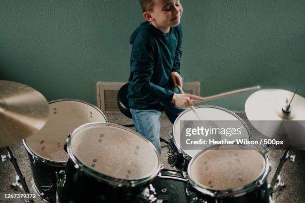 boy playing drums at home - drum kit stock pictures, royalty-free photos & images