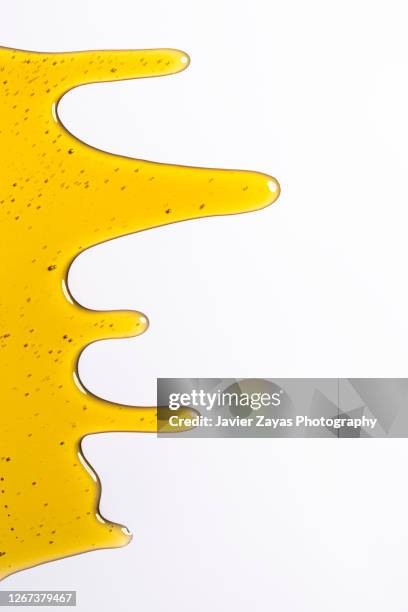 honey on a white colored background - slimed stock-fotos und bilder