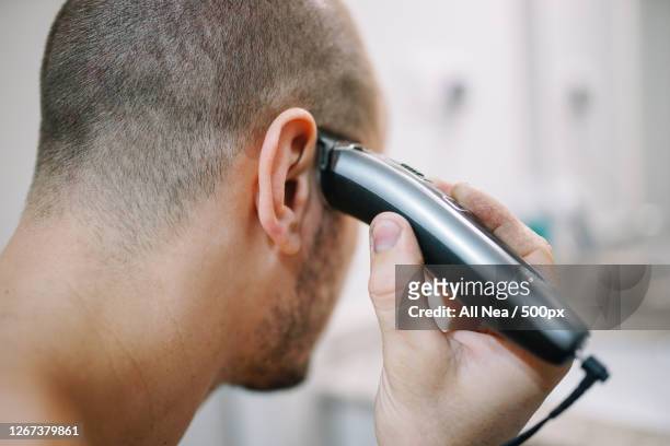 close-up of man shaving his own head, lleida, spain - head shave stockfoto's en -beelden