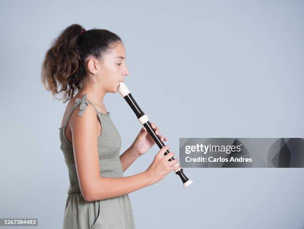 young girl playing the flute - recorder stock pictures, royalty-free photos & images