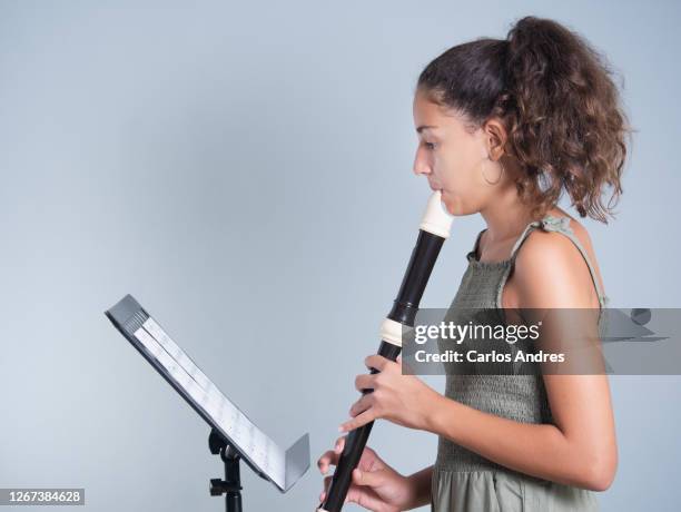 young girl playing the baroque flute - pentagramm stock-fotos und bilder